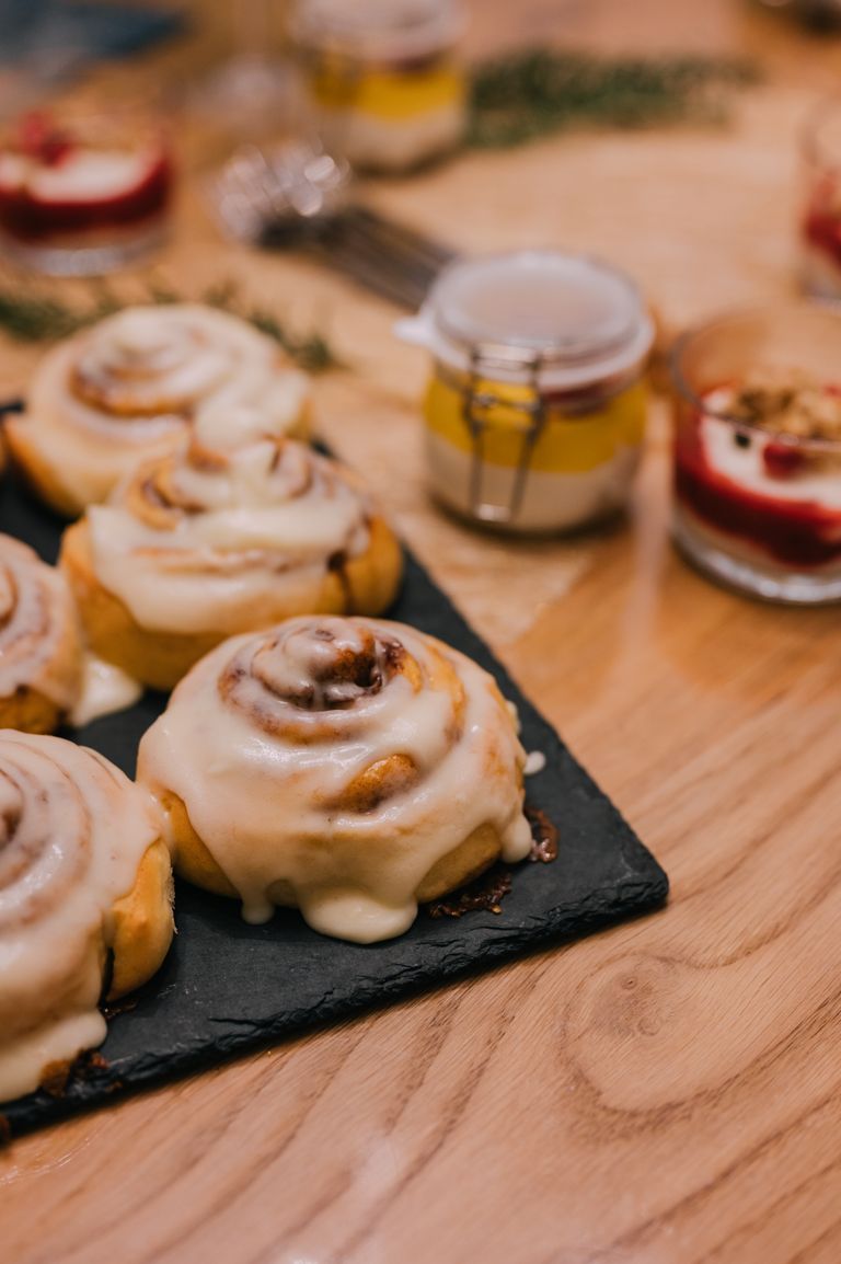 Close-up of mouthwatering cinnamon rolls topped with creamy icing, perfect for dessert lovers.